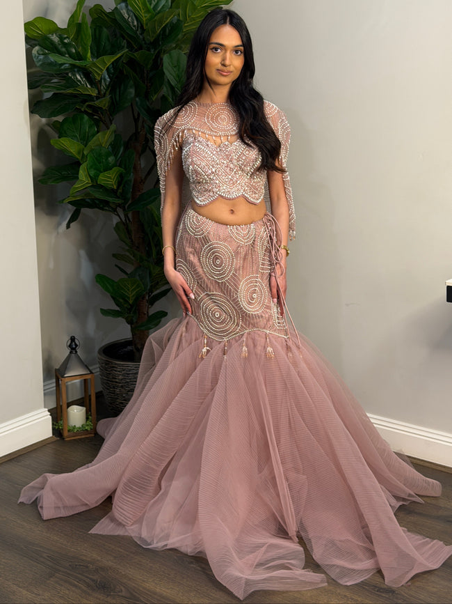 Vaerani Blush Pink Fishtail Lehenga With Cape styled on a model for visual reference